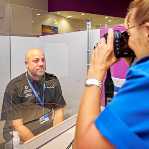 a photo of an ID centre colleague taking a photo of a London Gatwick colleague for their new ID pass